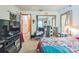 Bedroom featuring double closet, neutral walls, with a bed with colorful patchwork quilt at 418 W Holly Dr, Orange City, FL 32763