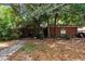 Quaint brick home with mature trees providing shade and curb appeal at 418 W Holly Dr, Orange City, FL 32763