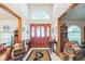 Bright foyer with a high ceiling, tile floor, and ornate front door at 418 W Holly Dr, Orange City, FL 32763
