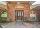 Front entrance with brick facade, decorative windows and bench seating at 418 W Holly Dr, Orange City, FL 32763