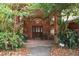 Covered front porch featuring brick columns and a seating area at 418 W Holly Dr, Orange City, FL 32763