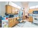 Bright kitchen with white appliances, a skylight, and tiled floors at 418 W Holly Dr, Orange City, FL 32763