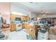 Large kitchen with wood cabinets, white appliances, and an open layout at 418 W Holly Dr, Orange City, FL 32763