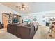 Spacious living room featuring a ceiling fan, entertainment center, and comfortable seating area at 418 W Holly Dr, Orange City, FL 32763