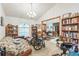 Bright living room with a view of the front door, carpet, and bookshelves at 418 W Holly Dr, Orange City, FL 32763