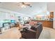 Comfortable living room with a ceiling fan, neutral carpet, a large sofa and an aquarium at 418 W Holly Dr, Orange City, FL 32763