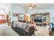 Large living room showcasing a carpet, a large sofa, and entertainment center at 418 W Holly Dr, Orange City, FL 32763