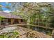 Backyard pool featuring a screened-in enclosure and lush landscaping at 418 W Holly Dr, Orange City, FL 32763
