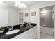 Elegant bathroom with double sinks, granite countertops, white cabinets, and a separate shower and tub at 5545 Misty Oak Cir, Davenport, FL 33837
