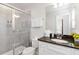 Well-lit bathroom with granite counters, a glass shower and vanity storage at 5545 Misty Oak Cir, Davenport, FL 33837