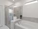 Modern bathroom featuring a glass shower, soaking tub, and elegant tile work at 5545 Misty Oak Cir, Davenport, FL 33837