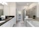 Bright bathroom with double sinks, soaking tub, and glass-enclosed shower at 5545 Misty Oak Cir, Davenport, FL 33837