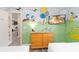 Whimsical bedroom featuring 'Dr. Seuss' wall murals, two twin beds and a dresser with a flat screen TV at 5545 Misty Oak Cir, Davenport, FL 33837