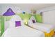 Charming ' bedroom with two white twin beds and whimsical 'Dr. Seuss' themed wall murals at 5545 Misty Oak Cir, Davenport, FL 33837
