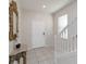 Inviting foyer with tiled floor, staircase, and decorative mirror creates a welcoming entrance at 5545 Misty Oak Cir, Davenport, FL 33837