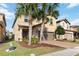 Stunning two-story home featuring a well-kept lawn, brick-paved driveway, and a two-car garage at 5545 Misty Oak Cir, Davenport, FL 33837