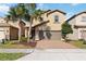 Charming two-story home with a well-manicured lawn and a two-car garage is perfect for families at 5545 Misty Oak Cir, Davenport, FL 33837