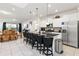 Open-concept kitchen with a large island, stainless steel appliances, and ample seating for casual dining at 5545 Misty Oak Cir, Davenport, FL 33837