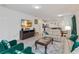 Cozy living area featuring comfortable seating, a modern entertainment center, and plenty of natural light at 5545 Misty Oak Cir, Davenport, FL 33837
