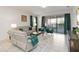 Bright living room with comfortable seating, stylish decor, and a view of the outdoor area with a pool at 5545 Misty Oak Cir, Davenport, FL 33837
