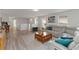 Spacious living room features hardwood floors, modern furniture, and plenty of natural light at 5545 Misty Oak Cir, Davenport, FL 33837