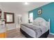 Comfortable bedroom featuring a large bed, stylish decor, and an attached bath with a walk-in shower at 5545 Misty Oak Cir, Davenport, FL 33837