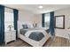 Bright main bedroom features a comfortable bed, natural light, and custom window coverings at 5545 Misty Oak Cir, Davenport, FL 33837