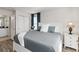 Bright main bedroom features a comfortable bed, natural light, and ensuite bathroom access at 5545 Misty Oak Cir, Davenport, FL 33837