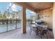 Outdoor covered patio with poolside dining and grilling area, perfect for entertaining at 5545 Misty Oak Cir, Davenport, FL 33837