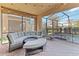 Relaxing covered patio with plush seating overlooking the pool and lush backyard at 5545 Misty Oak Cir, Davenport, FL 33837