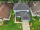 Aerial shot of the well-maintained house featuring a neatly landscaped yard and a spacious driveway at 9525 Southern Garden Cir, Altamonte Springs, FL 32714