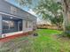 Lush backyard showing a covered patio, mature trees, and partial view of a wooden fence at 9525 Southern Garden Cir, Altamonte Springs, FL 32714