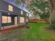 Spacious backyard featuring a covered patio, mature trees, and a wooden fence for added privacy at 9525 Southern Garden Cir, Altamonte Springs, FL 32714