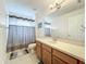 Bright bathroom featuring a shower-tub combo and a single sink vanity with white countertop at 9525 Southern Garden Cir, Altamonte Springs, FL 32714