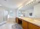 Bright bathroom featuring a shower, a tub, and a double sink vanity with plenty of lighting at 9525 Southern Garden Cir, Altamonte Springs, FL 32714