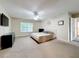 Open bedroom with a large window, neutral-toned walls, carpeted floors, and a ceiling fan at 9525 Southern Garden Cir, Altamonte Springs, FL 32714