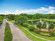 A brick sign at the Camden Club entrance is surrounded by landscaping and a pond with a fountain at 9525 Southern Garden Cir, Altamonte Springs, FL 32714
