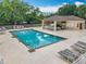 A relaxing community pool with a covered cabana, lounge chairs, and well-maintained surroundings at 9525 Southern Garden Cir, Altamonte Springs, FL 32714