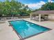 Beautiful community pool featuring a covered cabana with ample seating and a pristine fenced-in pool area at 9525 Southern Garden Cir, Altamonte Springs, FL 32714