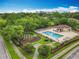 Aerial view of a community pool area with a playground and landscaping for ultimate relaxation and recreation at 9525 Southern Garden Cir, Altamonte Springs, FL 32714