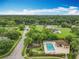Aerial shot of a community pool and playground surrounded by lush trees, creating an inviting outdoor recreation space at 9525 Southern Garden Cir, Altamonte Springs, FL 32714