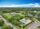 Aerial view of a community pool and playground surrounded by lush trees and landscaping for outdoor recreation at 9525 Southern Garden Cir, Altamonte Springs, FL 32714