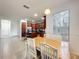 Open dining area with wood table and white chairs next to the kitchen at 9525 Southern Garden Cir, Altamonte Springs, FL 32714
