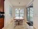 The dining area features a wood table, white chairs, and natural lighting at 9525 Southern Garden Cir, Altamonte Springs, FL 32714