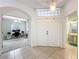 Bright entryway with an arched view into the home office and access to a conveniently located half bathroom at 9525 Southern Garden Cir, Altamonte Springs, FL 32714