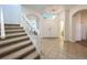 Light and airy foyer with tile flooring, leading to a staircase with white railing at 9525 Southern Garden Cir, Altamonte Springs, FL 32714