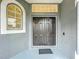 Front entrance with double black doors beneath decorative windows and next to a large window at 9525 Southern Garden Cir, Altamonte Springs, FL 32714