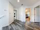 Bright hallway with wood-look floors giving access to bedrooms at 9525 Southern Garden Cir, Altamonte Springs, FL 32714