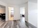 Hallway with wood-look laminate flooring leading to bedrooms and bathroom at 9525 Southern Garden Cir, Altamonte Springs, FL 32714