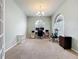 Dedicated home office space, featuring a large arched window and ample room for multiple workstations at 9525 Southern Garden Cir, Altamonte Springs, FL 32714